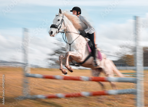 Once you build trust, you will soar. a young rider jumping over a hurdle on her horse.
