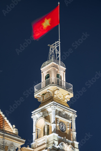 Traffic in front of Ho Chi Minh City Hall, Saigon City Hall or Committee Head office in the evening, Vietnam. Light trail and night. Popular place to visit in Saigon. Travel destinations in Vietnam photo