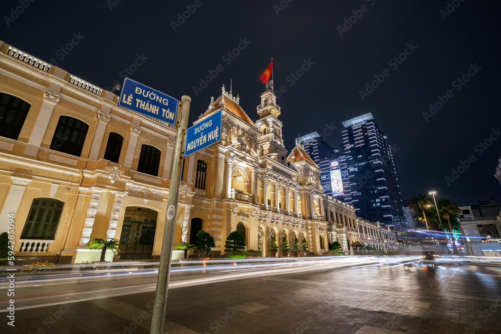 Traffic in front of Ho Chi Minh City Hall, Saigon City Hall or Committee Head office in the evening, Vietnam. Light trail and night. Popular place to visit in Saigon. Travel destinations in Vietnam