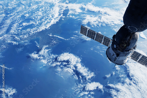 Fototapeta Naklejka Na Ścianę i Meble -  A space satellite above the Earth's surface. Elements of this image furnished NASA.