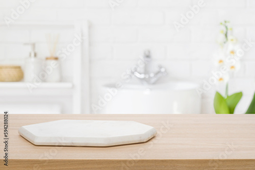 Marble podium for bathing product display on blurred bathroom background