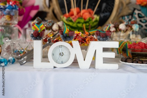Creative white love design with a clock with blur decorated bouquet during a wedding