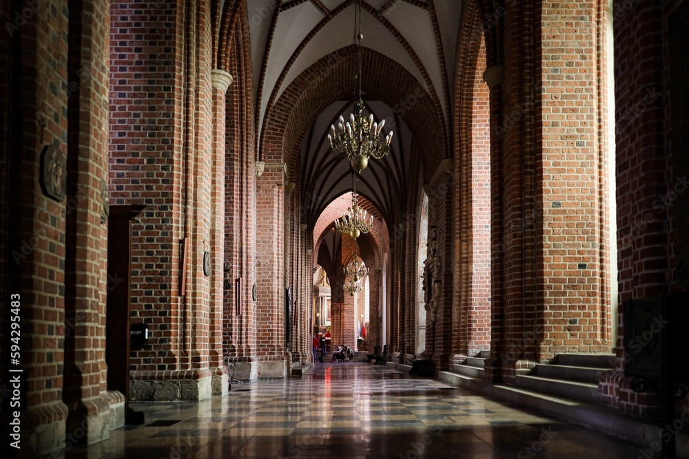 an interior view of an cathedral with red bricks and ornate ceilinging