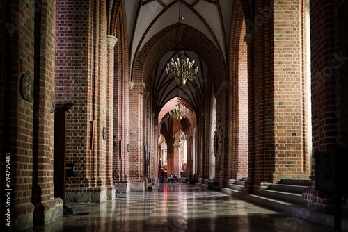 an interior view of an cathedral with red bricks and ornate ceilinging