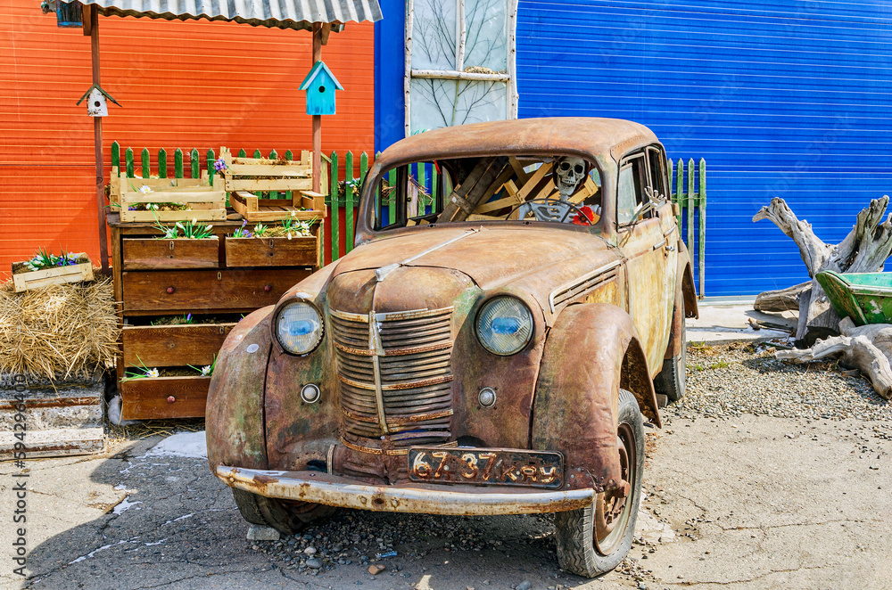 Abakan, Russia 04.19.2023: Skeleton driving an old, rusty car