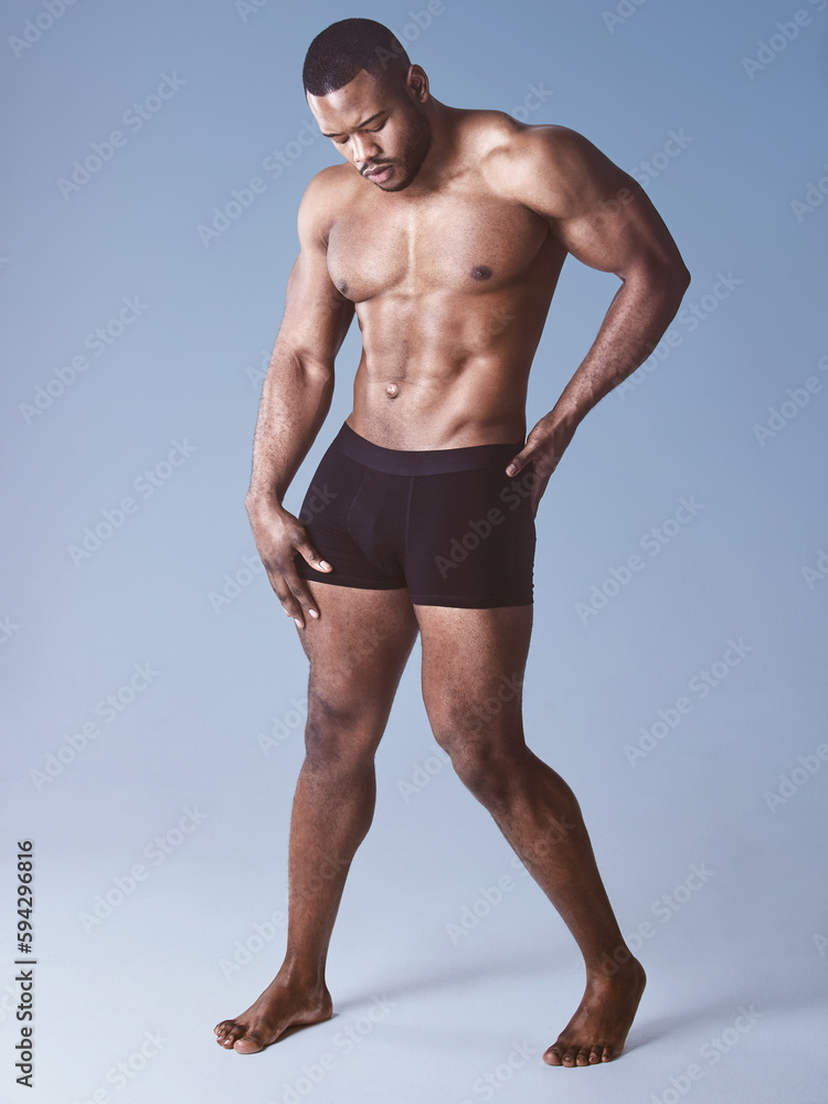 Ive got those rock hard abs. Full length shot of a handsome young man posing shirtless in the studio.