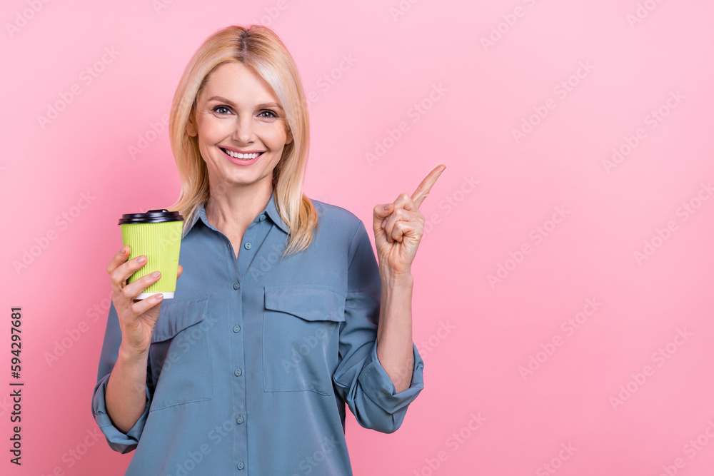 Photo of middle age promoter businesswoman broker hold plastic cup drink direct finger mockup latte macchiato brand isolated on pink color background Photo of middle age promoter businesswoman broker hold plastic cup drink direct finger mockup latte macchiato brand isolated on pink color background