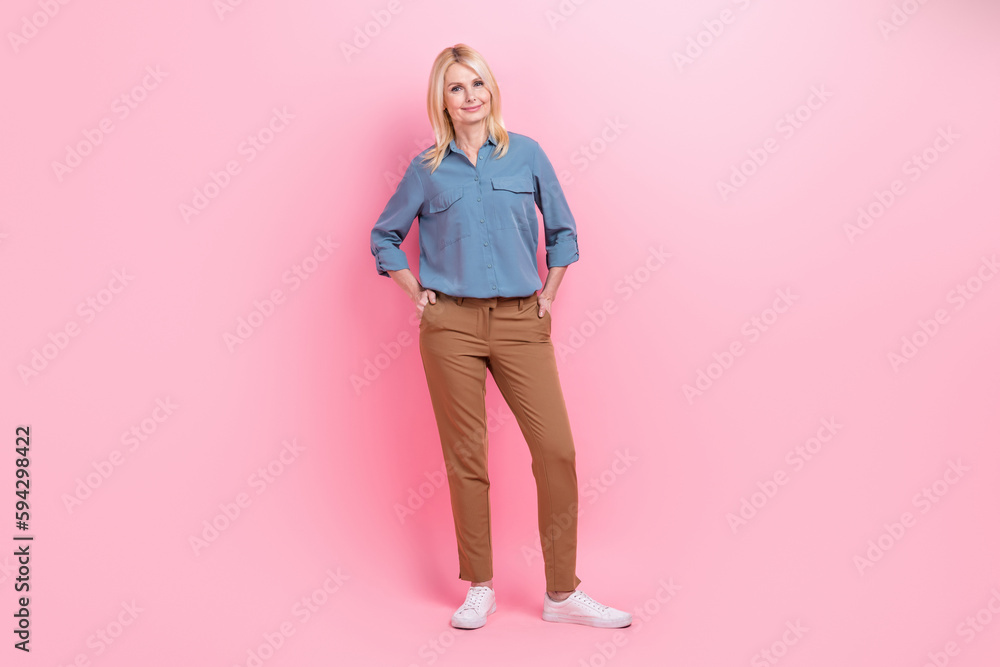 Full body photo of confident business owner expert pensioner woman hands pockets stylish outfit office worker isolated on pink color background