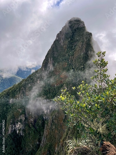 Landscape of the stunning mountains of Machu Picchu covered in the fog in Peru