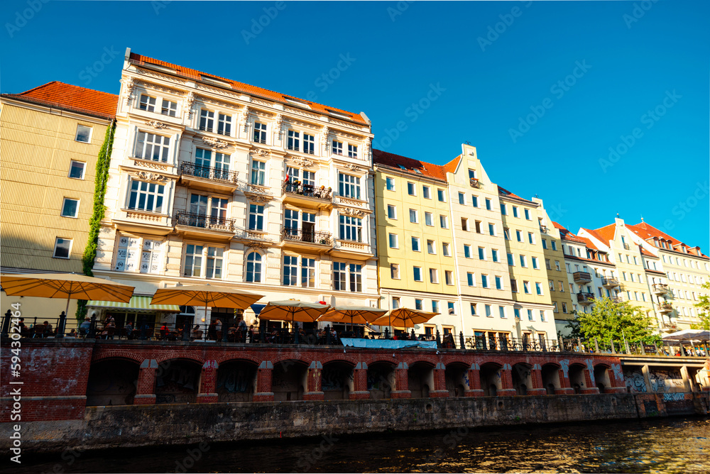 BERLIN - GERMANY, MAY 26, 2017: Buildings of town landscape in sunset from pleasure boat view on Spree river