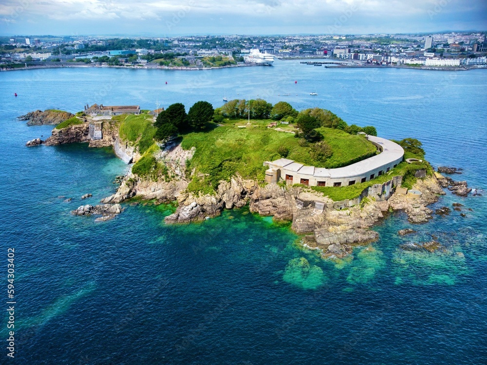 Fototapeta premium View of Drake's Island in Plymouth UK, blue sky with white clouds