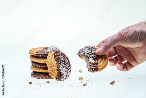 Closeup of half-eaten cookies with coconut and chocolate isolated on a white background