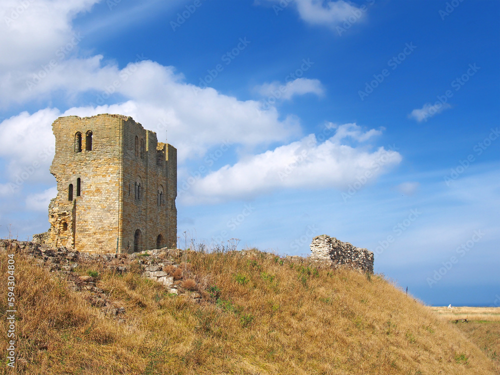 Hilltop view of the keep and wall of the ruined historic Scarborough castle in yorkshire.