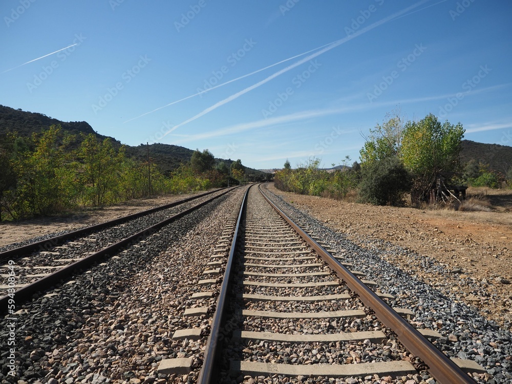 Scenic view of an abandoned railroad track, with no train or people in sight Scenic view of an abandoned railroad track, with no train or people in sight