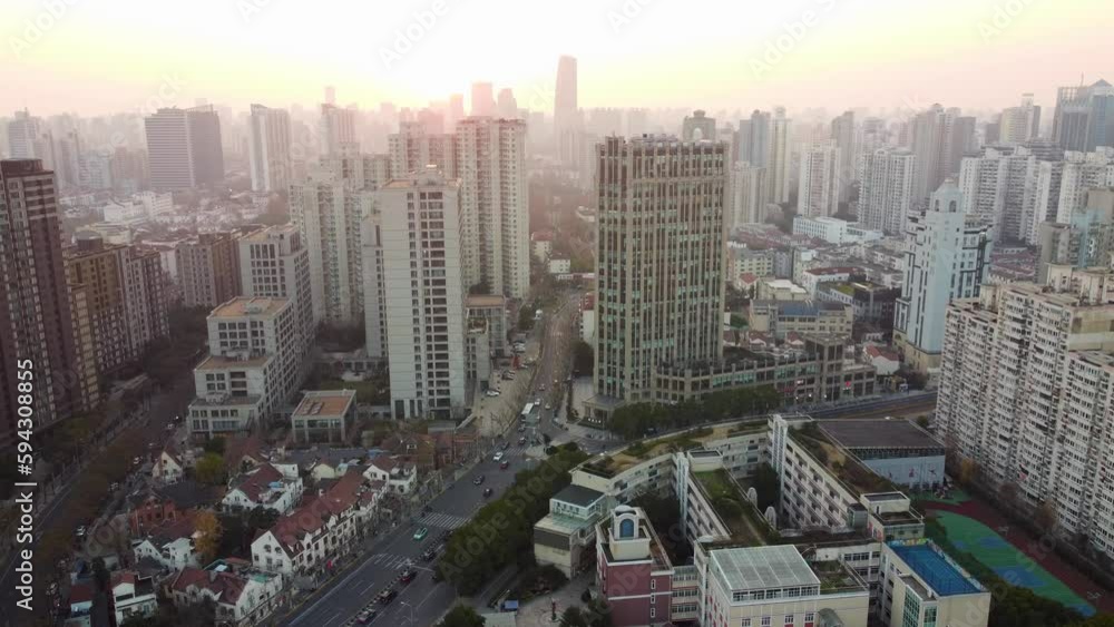 Drone view over a cityscape with high-rise buildings during a sunset Drone view over a cityscape with high-rise buildings during a sunset