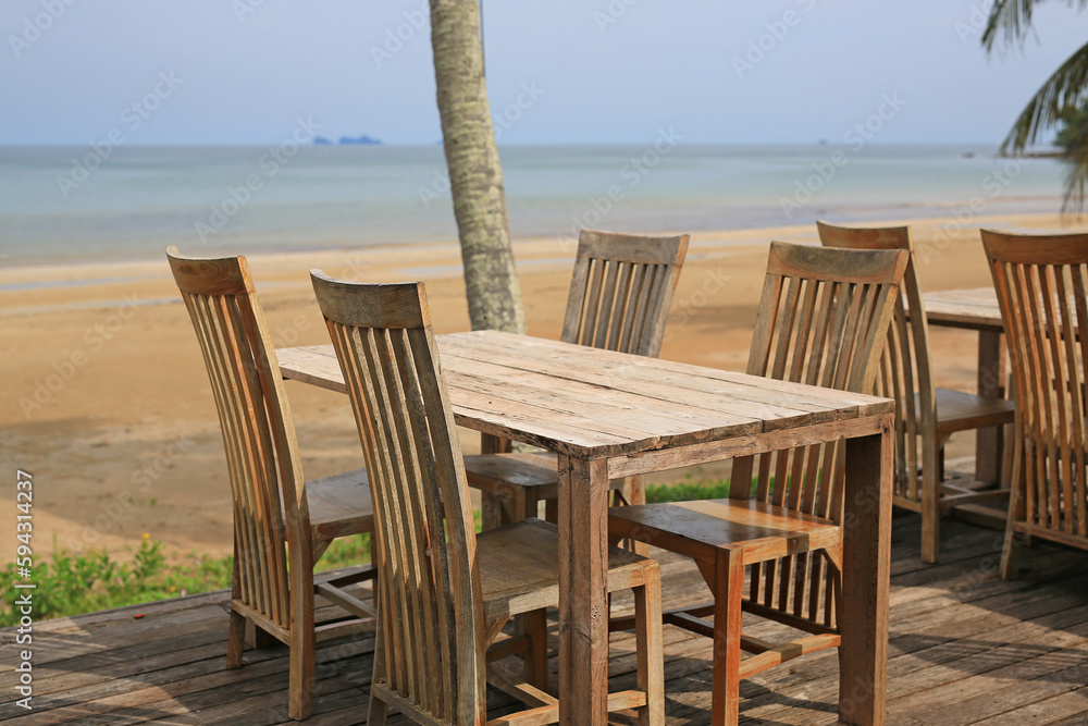 Empty wood table and chairs at restaurants near the beach. Empty wood table and chairs at restaurants near the beach.