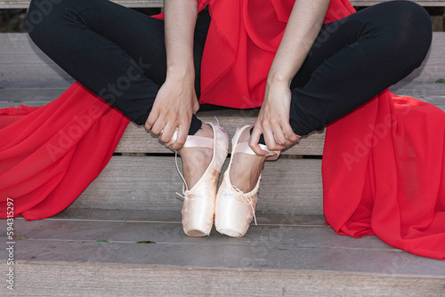 Obraz na płótnie Ballerina in nature, Student woman wear old shoe ,practice ballet outdoor, sit relax at stair background. Health lifestyle image. w salonie