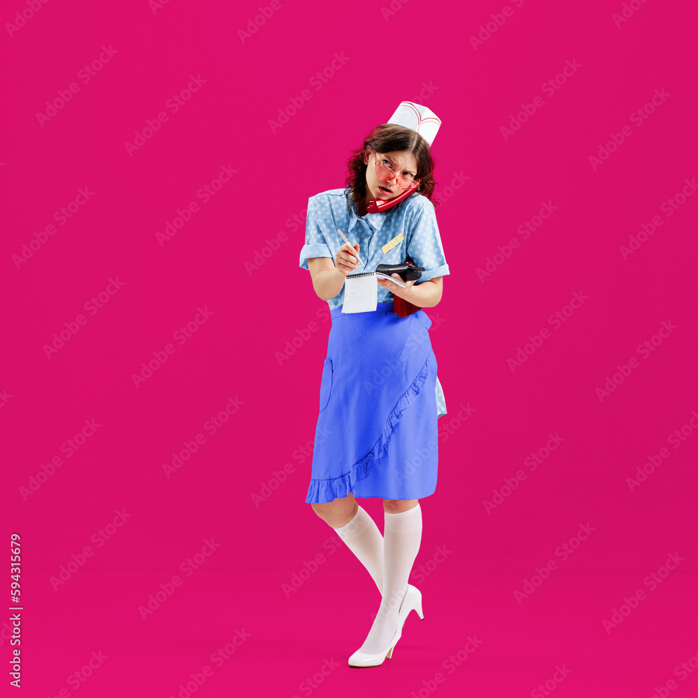 Beautiful young girl in image of retro cater waiter wearing 70s, 80s fashion style uniform isolated over bright pink background. Trash pop art. Charm, ad, sales, fashion, emotions Beautiful young girl in image of retro cater waiter wearing 70s, 80s fashion style uniform isolated over bright pink background. Trash pop art. Charm, ad, sales, fashion, emotions
