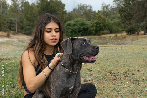 Woman caressing Cane Corso dog