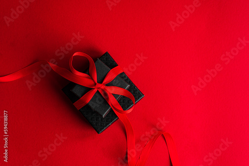 Black gift box with red ribbon photo