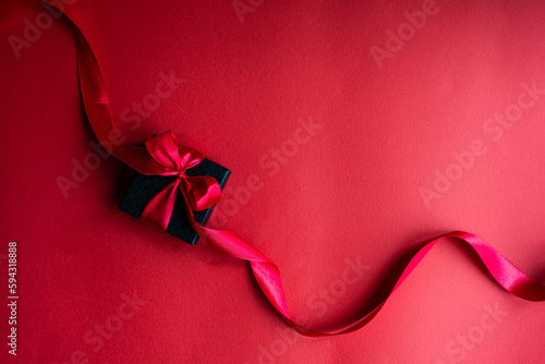Black gift box with red ribbon photo