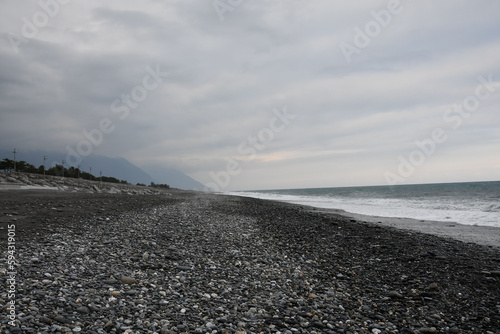 Black and rocky beach at the coast in Xincheng Township, Taiwan photo