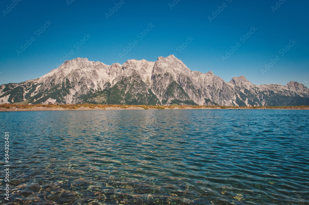 Asitz mountain in the background of the pure and calm lake, Austria