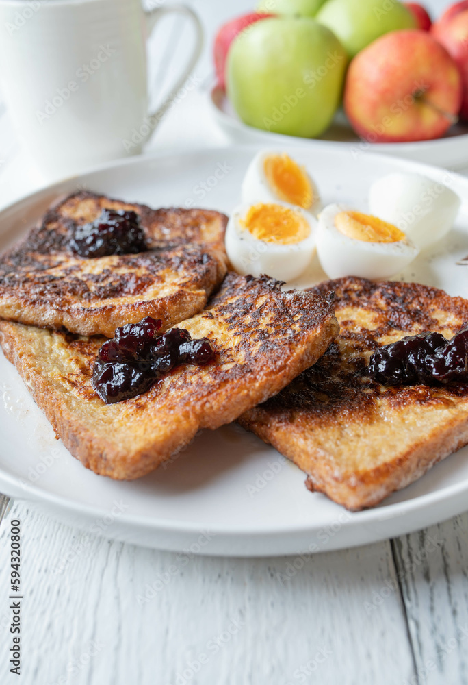 French toast with blueberry jam and boiled eggs on a plate for breakfast French toast with blueberry jam and boiled eggs on a plate for breakfast