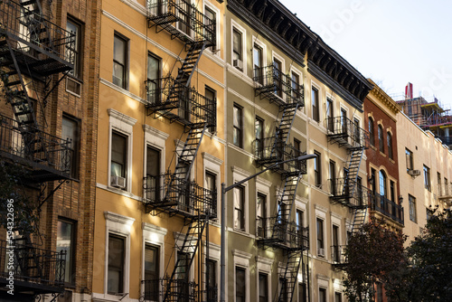 Row of Colorful Old Apartment Buildings with Fire Escapes in Chelsea of New York City