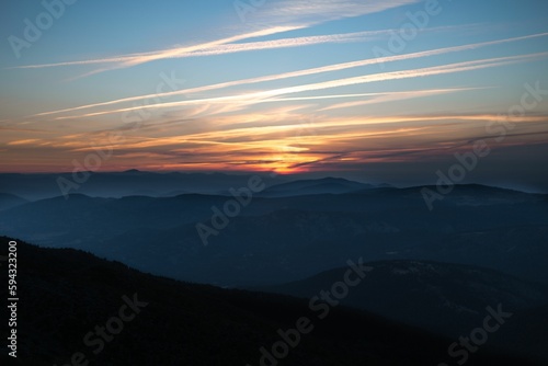 Beautiful sunset over a highland with mountain range © Hamza Oulad/Wirestock Creators