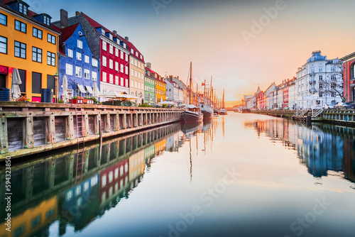 Copenhagen, Denmark. Nyhavn, Kobenhavn's iconic canal, colorful sunrise water reflection.