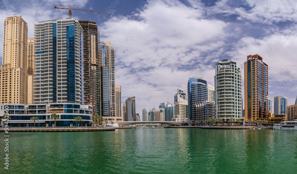 Fototapeta premium Tall apartment blocks surround the water at Dubai Marina in the UAE
