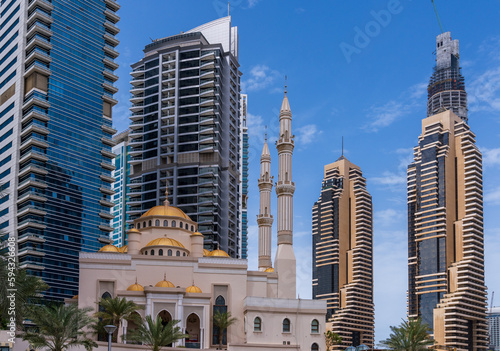 Tablou pe pânză Mosque with minarets surrounded by tower blocks at Dubai Marina