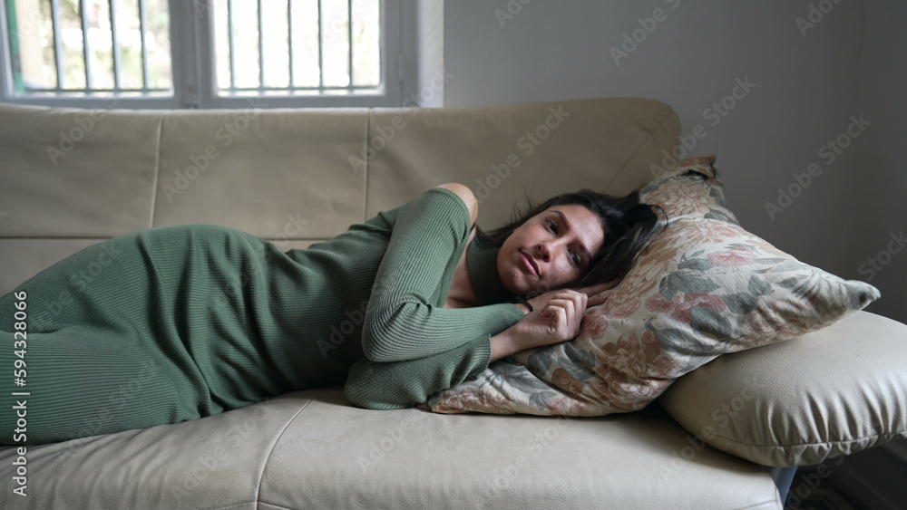 Relaxation time for a young Arab woman on the couch. Middle Eastern adult girl unwinding and de-stressing Relaxation time for a young Arab woman on the couch. Middle Eastern adult girl unwinding and de-stressing