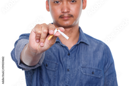 Man holding broken cigarette in hands isolated on white background. Stop smoking cigarettes concept. No smoking.