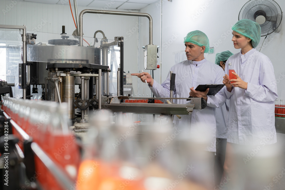 A quality supervisor or food or beverages technician discuss about process control of food and drugs before send product to the customer. Production leader recheck ingredient and productivity. A quality supervisor or food or beverages technician discuss about process control of food and drugs before send product to the customer. Production leader recheck ingredient and productivity.