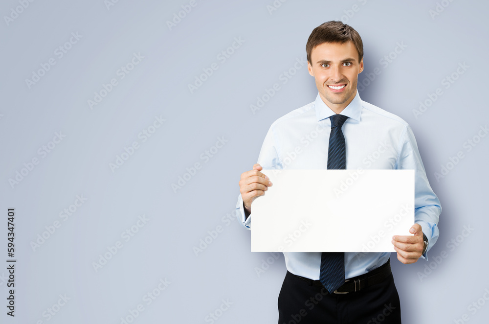 Image of business man professional bank manager in confident cloth, wear shirt, necktie tie. Standing businessman holding, showing empty white banner sign board. Isolated grey gray background Image of business man professional bank manager in confident cloth, wear shirt, necktie tie. Standing businessman holding, showing empty white banner sign board. Isolated grey gray background
