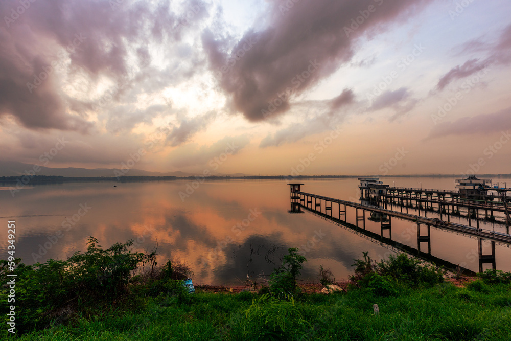 The background of the sea by the evening sea, with natural beauty (sea water, rocks, sky) and fishermen are fishing by the river bank, is a pleasure during travel.