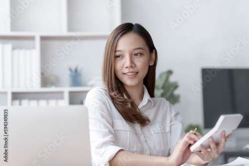 Confident Asian businesswoman calculating finances in the accounting and balance sheet work of the stock market and international exchange rates, Authorized Share Capital, Owners Equity, Common Stock