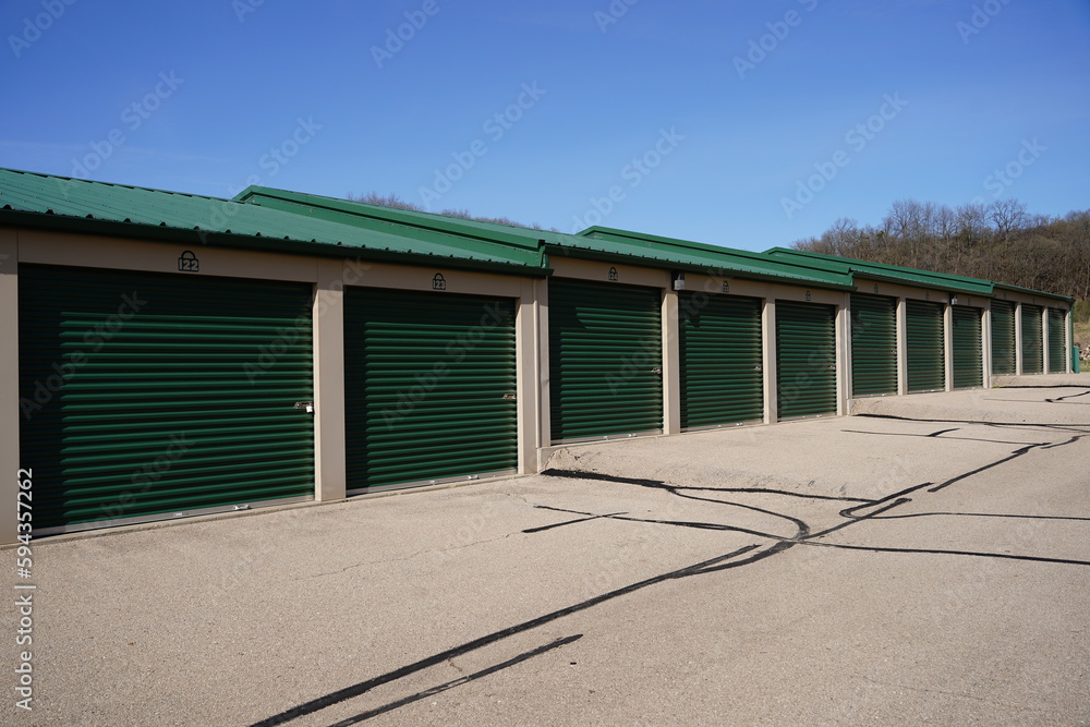 Green and white storage units are being used to hold rental property and belongings. Green and white storage units are being used to hold rental property and belongings.