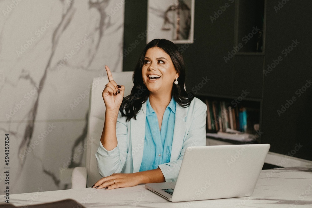 Female professional at her home office, smiling with contentment Female professional at her home office, smiling with contentment