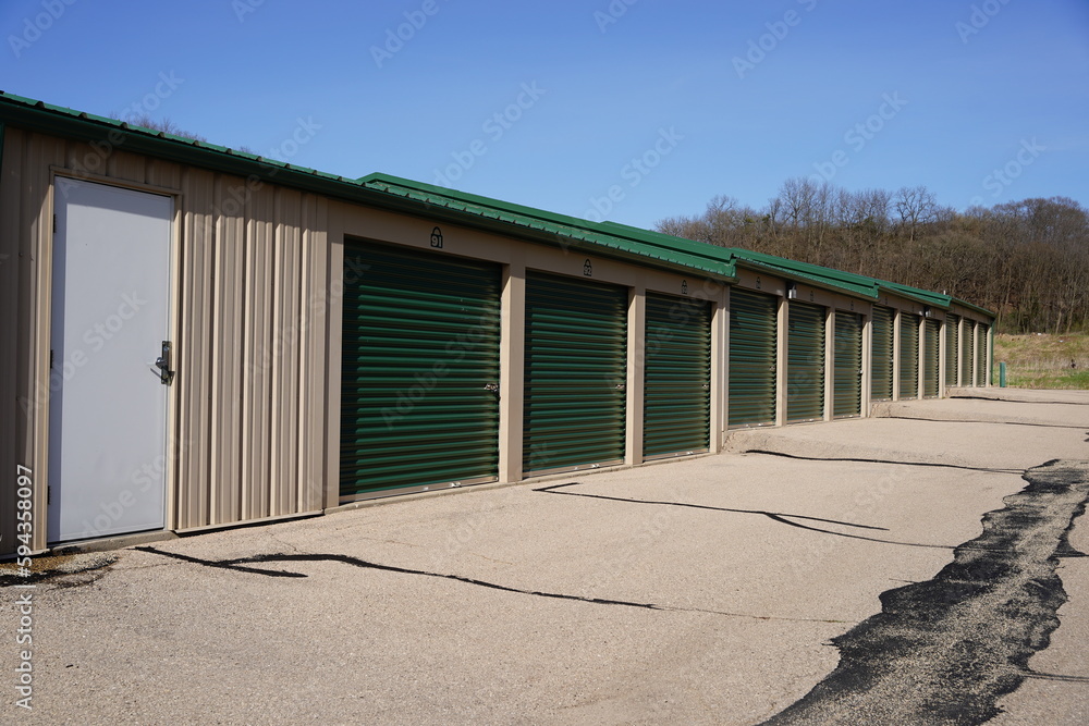 Green and white storage units are being used to hold rental property and belongings. Green and white storage units are being used to hold rental property and belongings.