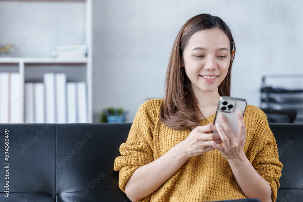 Using mobile phone, Pretty young asian woman housewife relax on comfortable sofa feels satisfied accomplish chores housework concept Using mobile phone, Pretty young asian woman housewife relax on comfortable sofa feels satisfied accomplish chores housework concept