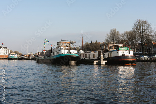 Aesthetic canals of Amsterdam at sunset, view from the water, houseboats on the canal, houseboats hotels. Romantic canal boat ride in Amsterdam - 12.04.2023