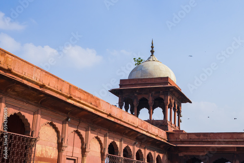 Tower of jama masjid, an ancient mosque of Delhi. The historical monument is made of red sandstone and white marble with indo-islamic architecture style. The sentry towers are used for watchkeeping.