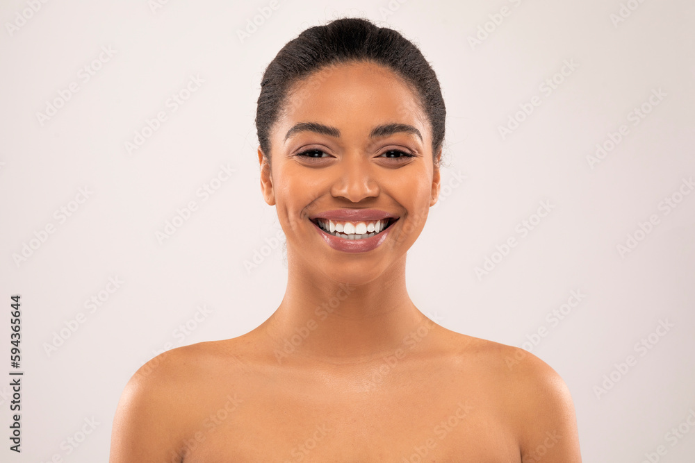 Cheerful millennial african lady posing half-naked on colorful background Cheerful millennial african lady posing half-naked on colorful background