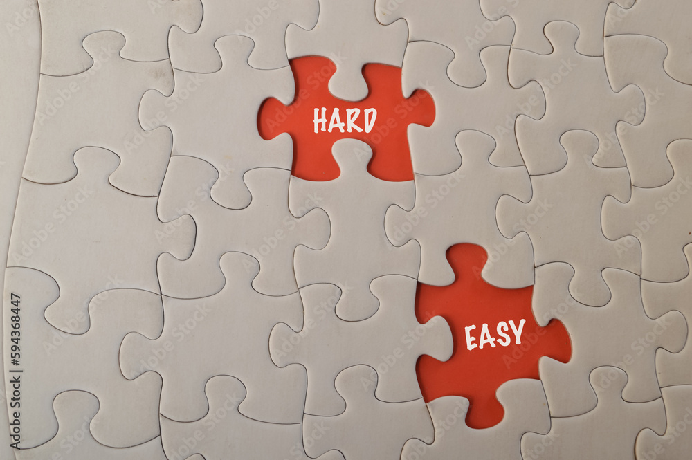 Fototapeta premium Missing jigsaw puzzle with text HARD and EASY.