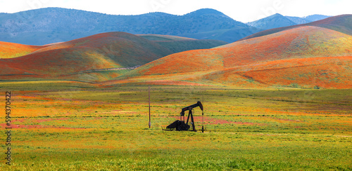 Abandoned oil well pump in the middle of scenic landscape at Carrizo plain national monument in California. photo