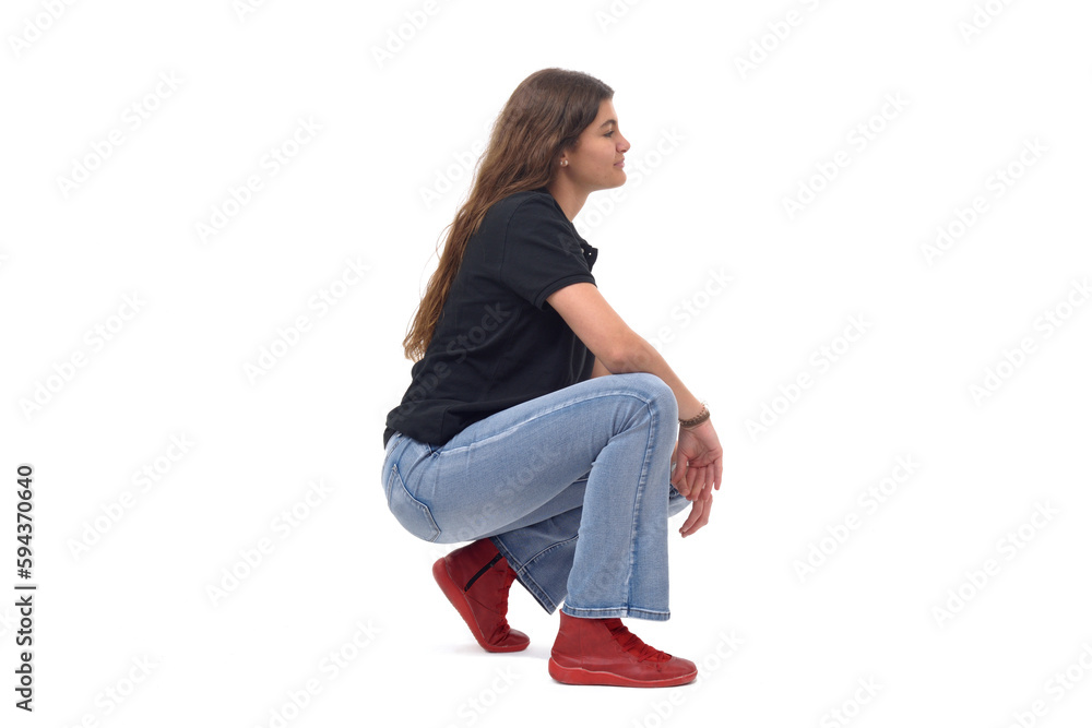 © curto - side view of a young girl long-haired sitting squatting on white background