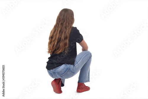 back and side  view of a young girl long-haired sitting squatting on white background